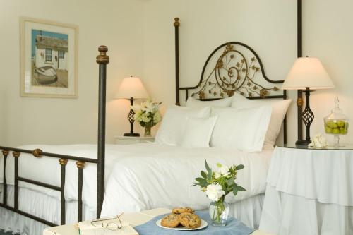 a bedroom with a black and white bed with a tray of cookies at Inn at Playa del Rey in Los Angeles