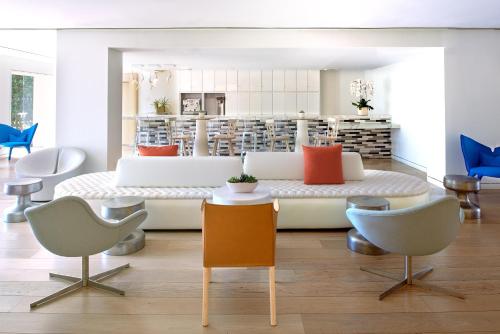 a living room with a couch and chairs at Mondrian Los Angeles in Los Angeles