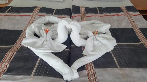 a bed with three towels on top of it at Hotel Haarener Hof in Bad Wünnenberg