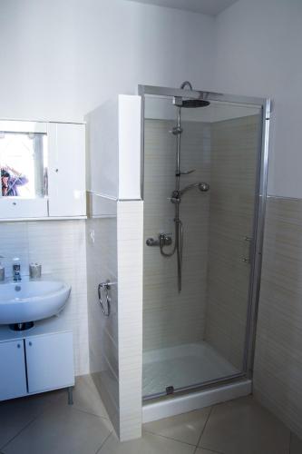 a bathroom with a shower and a sink at Villa Imma in Torre Lapillo