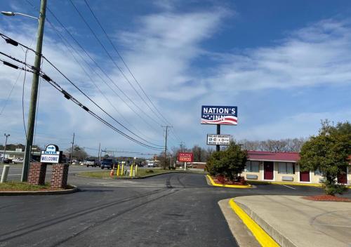 a sign for a nautilus gas station on a street at Nation's Inn Kinston in Kinston