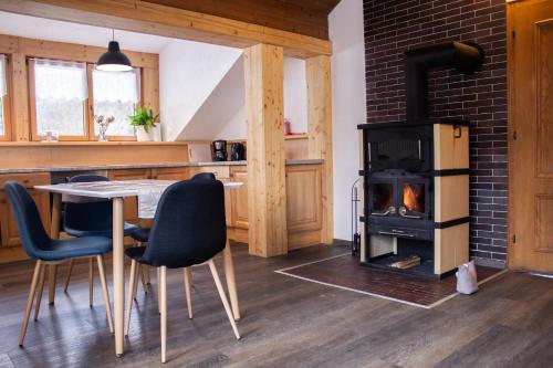 a kitchen with a table and a wood stove at Pepi‘s Apartment in Hallstatt