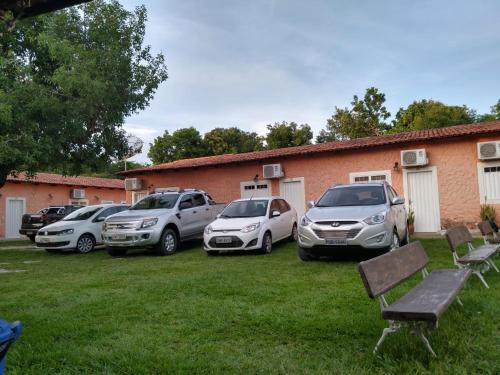 a group of parked cars parked in a yard at Pousada Portalcion in Goiás