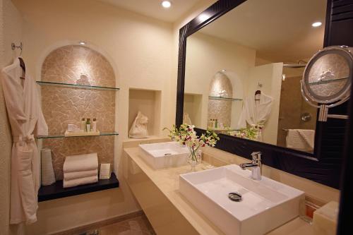 a bathroom with two sinks and a mirror at Dreams Playa Bonita All Inclusive in Playa Bonita Village