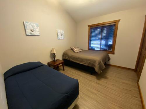 ein Schlafzimmer mit einem Bett und einem Fenster in der Unterkunft Wolf Den in Valemount