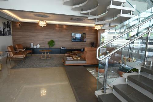 a living room with a staircase and a lobby at Figueiras Hotel & Eventos in São Miguel dʼOeste