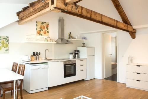 a kitchen with white appliances and a wooden floor at Über den Dächern Boppards in Boppard
