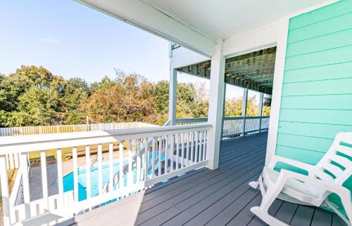 a porch with two chairs and a swimming pool at Family Tradition in Duck