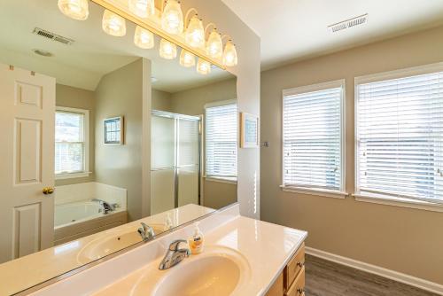 a bathroom with a sink and a large mirror at Family Tradition in Duck