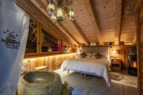 a room with a bed, a table, and a window at Park Chalet Village in Livigno