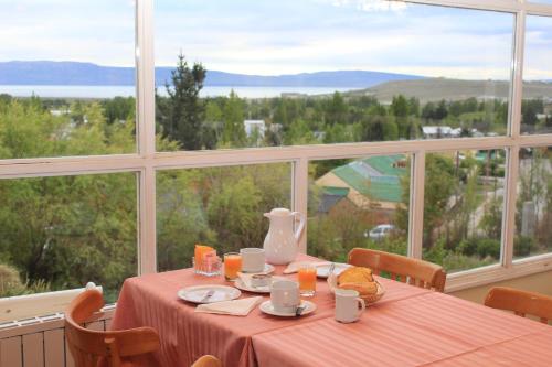 a table in a room with a large window at South B&B El Calafate in El Calafate