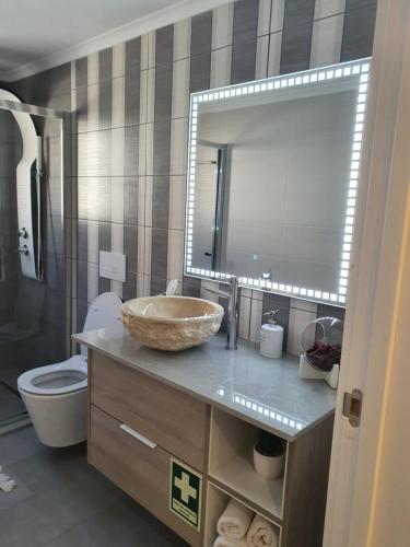 a bathroom with a sink and a toilet and a mirror at Marina Plaza 2 in Vilamoura