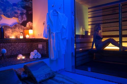 a woman sitting on a window sill in a room at Albergo Gatto Bianco in Capri