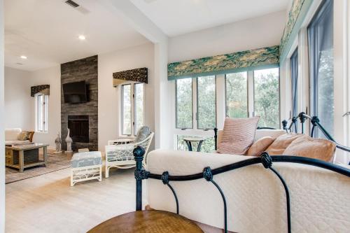 a bedroom with a bed and a living room with windows at Ocean Winds 3023 in Seabrook Island