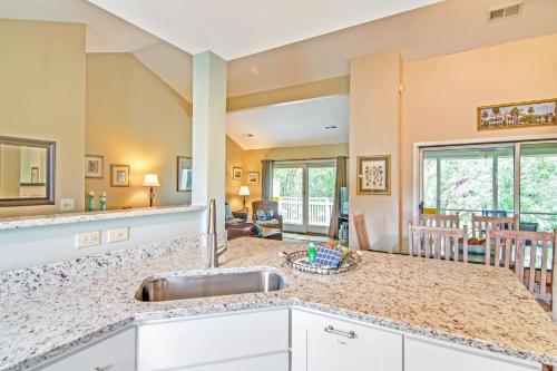 a kitchen with a sink and a living room at Fairway Dunes 3 in Isle of Palms