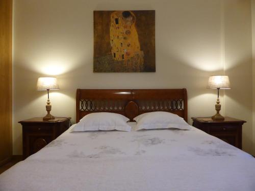 a bedroom with a large bed with two night stands at A View to the River Tejo by SixtyFive Boutique Home in Lisbon