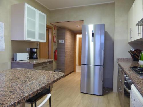 a kitchen with a stainless steel refrigerator at A View to the River Tejo by SixtyFive Boutique Home in Lisbon