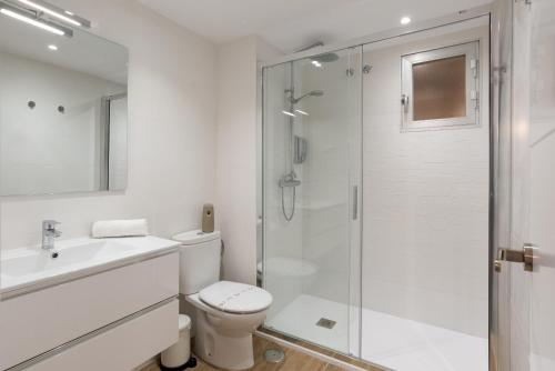a white bathroom with a toilet and a shower at Virginia Beach & private terrace by ELE Apartments in Málaga