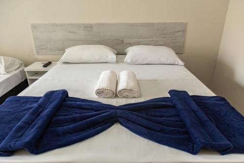 a bed with two towels on top of it at Pousada Maresia Unique Beira Mar in Porto De Galinhas