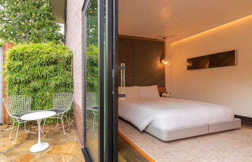 a bedroom with a bed and a table and chairs at The Hollywood Roosevelt in Los Angeles