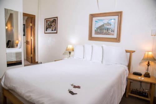 a bedroom with a large white bed with white pillows at Loft 3 - 1 of 5 downtown in Alpine