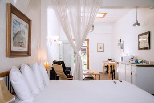 a bedroom with a large white bed and a kitchen at Loft 3 - 1 of 5 downtown in Alpine