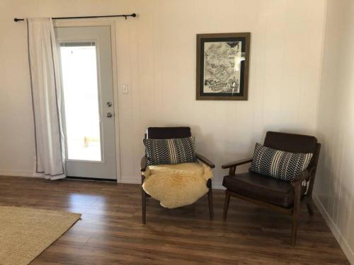 a living room with two chairs and a window at Beach House in Alpine in Alpine