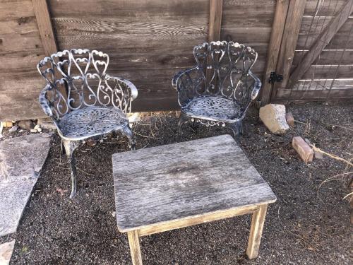 two chairs and a wooden table in a yard at Loft 3 - 1 of 5 downtown in Alpine