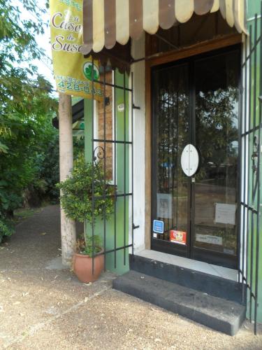 a store front with a clock in the window at La Casona de Susana in Colón