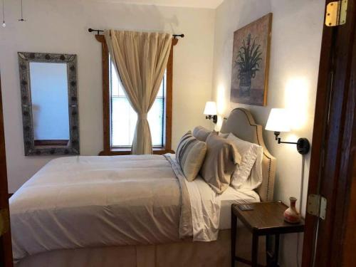 a bedroom with a large bed and a window at El Viejo Adobe - Across from Sul Ross campus in Alpine