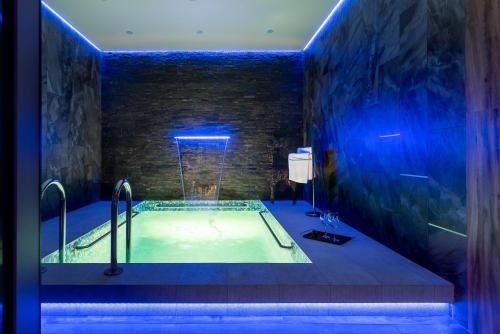 a bathroom with a bath tub with a pool of water at Sedanka Park Hotel in Vladivostok