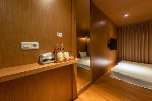 a small hotel room with a bed and a bedroom at Kontena Hotel in Batu