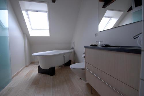 a bathroom with a bath tub and a toilet at Best Western Hotel Herman Bang in Frederikshavn