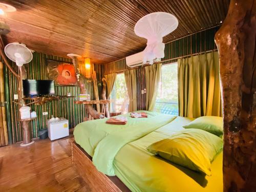 Khao Sok Tree House Resort في خاو سوك: غرفة نوم بسرير كبير في غرفة