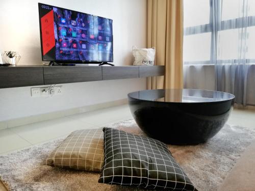 a living room with a television and a black bowl at I City Residence, 2 Bedroom 4-6 Pax unit, Walking to Theme n Water Park & Shopping Mall in Shah Alam