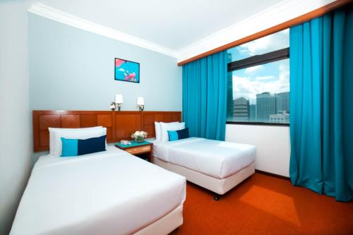 Una cama o camas en una habitación de JO Hotel Johor Bahru