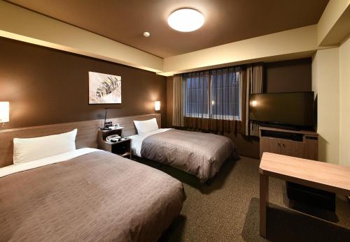 Postel nebo postele na pokoji v ubytování HOTEL ROUTE-INN Kamiyamada Onsen