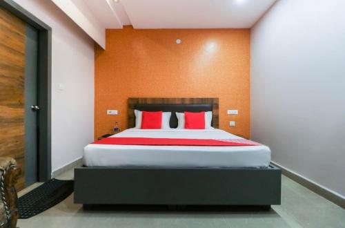 a bedroom with a large bed with red pillows at Hotel sagar villa in Karnal