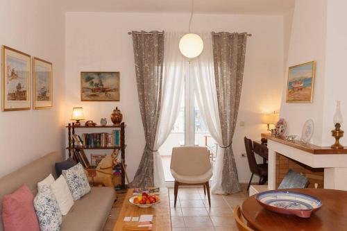 un soggiorno con divano e finestra di Estia House Cozy-Comfortable Apartment a Benitses