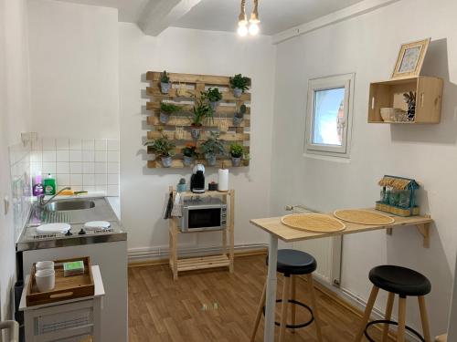 a kitchen with two bar stools and a counter top at So Amiens in Amiens