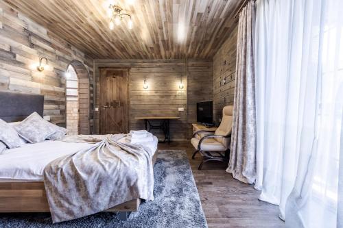 a bedroom with a bed and a wooden wall at Маєток "ZYMON & SKI" in Bukovel