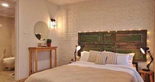 a bedroom with a bed and a white brick wall at Ananya Apartments Phase 2 in Kathmandu