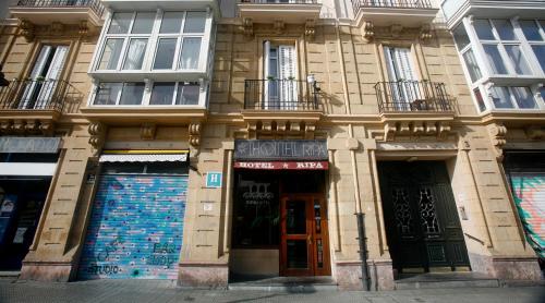 a large building with doors and windows on a street at Hotel Ripa in Bilbao