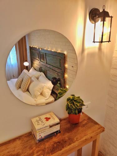 a mirror on a wall with a bed in a room at Ananya Apartments Phase 2 in Kathmandu