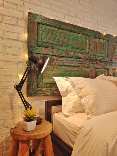 a lamp sitting on a table next to a bed at Ananya Apartments Phase 2 in Kathmandu