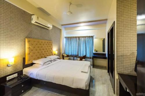 a bedroom with a large white bed in a room at Hotel Vaishnavi in Solapur