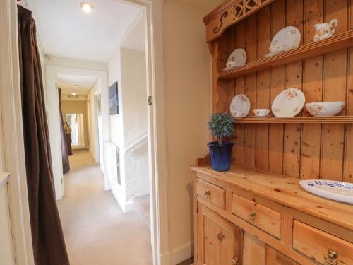 a bathroom with a sink and a wooden wall at Turret Cottage in Prestonpans