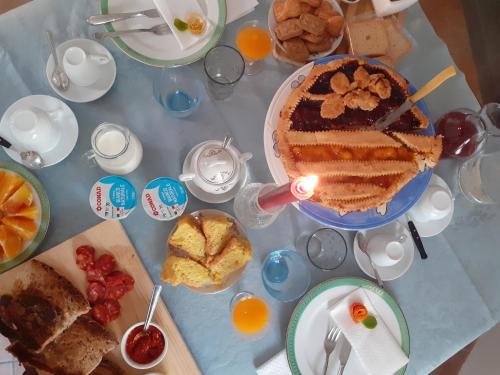 a table with a cake and various types of food at Le Terrazze Sul Pollino B&B in Civita
