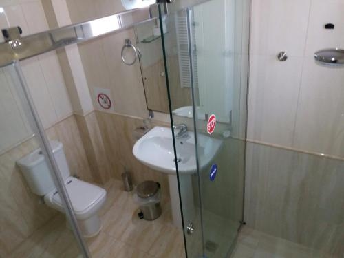 a bathroom with a toilet and a glass shower at HELEN in Artemida