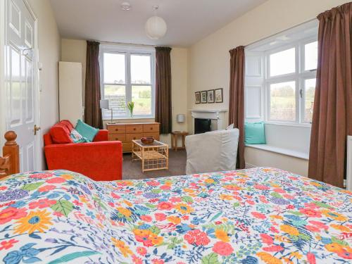 a bedroom with a bed and a living room at Garden View in Kington